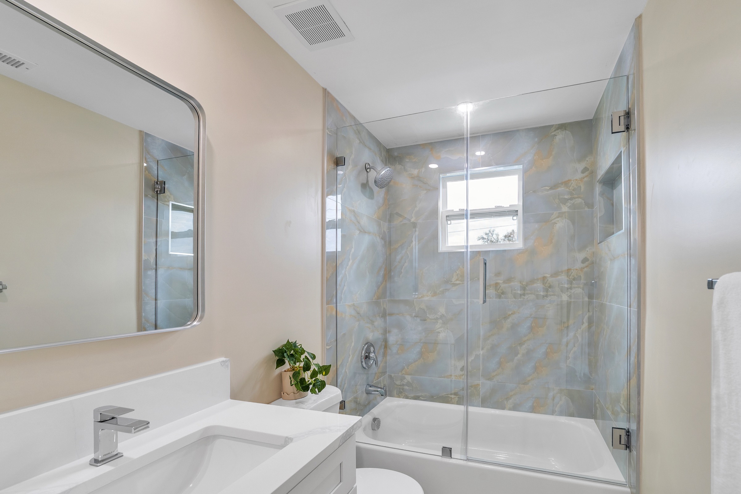 Luxury real estate photography Tampa — master bathroom with floor-to-ceiling blue marble shower