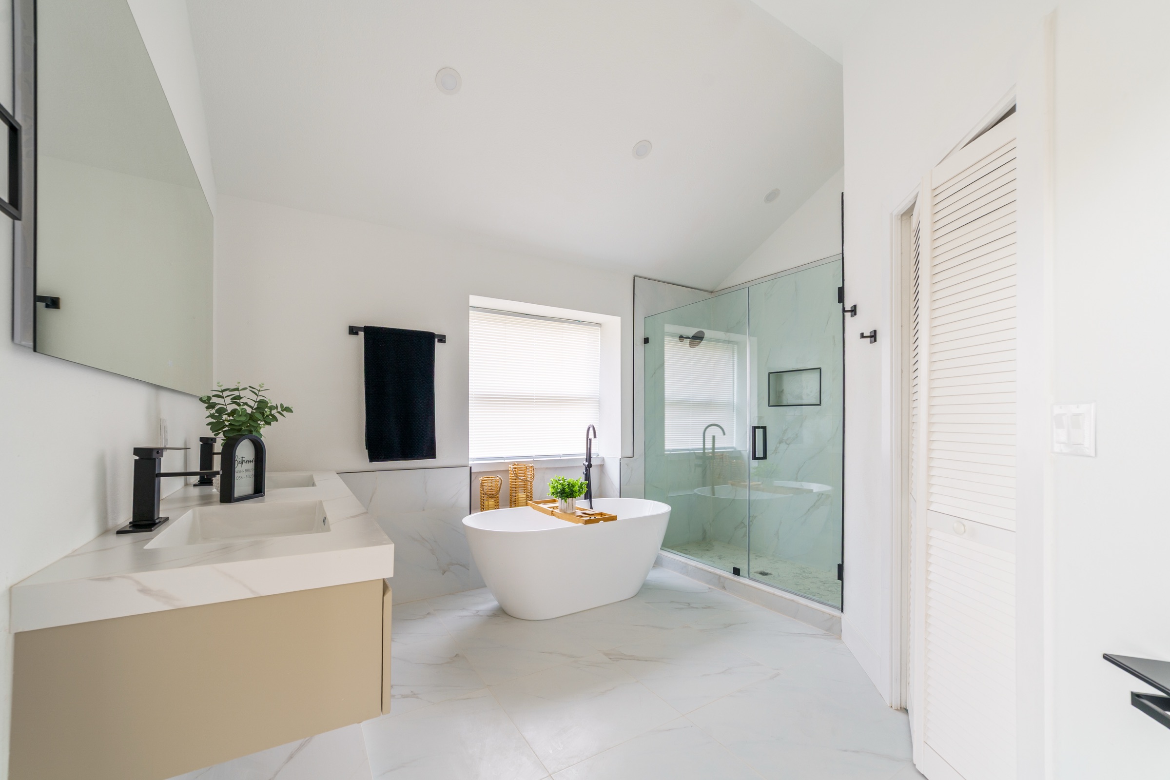 Luxury property photography Tampa FL — spa bathroom with freestanding soaking tub and soaring ceiling